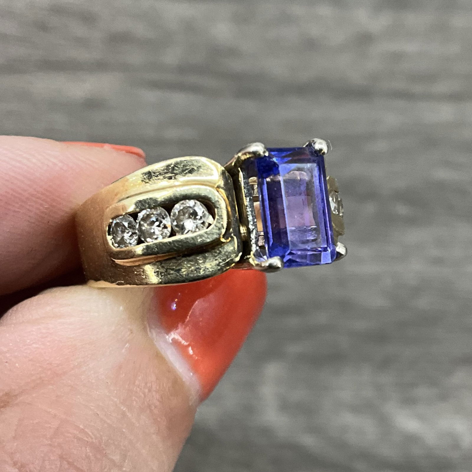Tanzanite Ring, 14 K Yellow Gold: Tanzanite, heat treated, white topaz and 14 K gold ring. Comes with box. Size: US 6