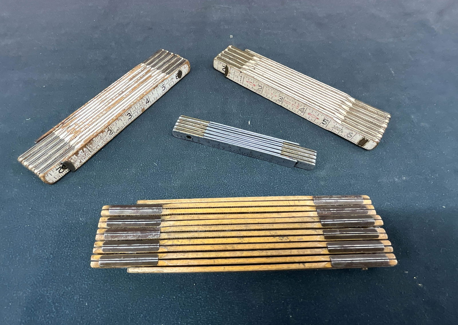 4 Vintage Folding Zig-Zag Rulers: Including 3 wood Carpenter's rules, and a metric steel machinist's ruler. Size: folded 8"