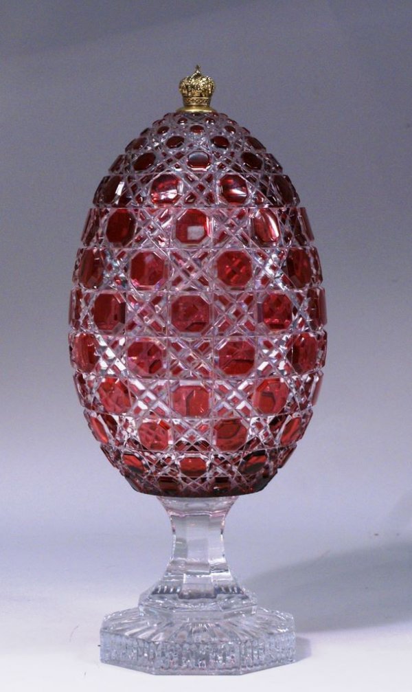 Limited Edition Faberge Crystal Presentation Egg: A limited edition Faberge Crystal 14"h cut glass Presentation Egg in fitted satin-lined velvet case, cased in cranberry and cut to clear, originally sold through Nieman Marcus.