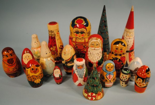 Collection of 18 Russian Nesting Dolls: A collection of 18 nesting doll boxes ranging from 3"h to 11"h, eight w/original Russian labels, one made in Poland, seven unmarked. Includes seven santas, Christmas trees, bunnies, and Russian girls