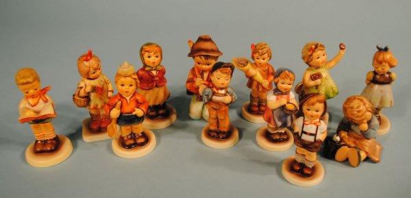Group of 12 Hummels: A grouping of 12 Hummel figures: #479 "I Brought You a Gift" TMK6 Hummel Club Ed., 4"h; #534 "A Nap" TMK7, 2 3/4"h; #2181 "Clear as a Bell" TMK8 Hummel club Ed., 4"h; #549/3/0 "A Sweet Offering" TMK7