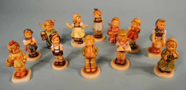 Group of 12 Hummels: A grouping of 12 Hummel figures: #73 "Little Helper" TMK6, 4 1/4"h; #2183 "Keeping Time" TMK8, 3 3/4"h; #912/B "Spring Waltz" TMK8, 4"h; #2103/A "Puppet Princess" TMK8, 3 3/4"h; #629 "From Me to You" 