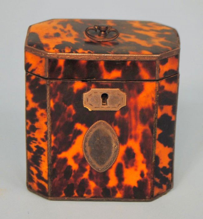 Tortoise Shell Silver-Mounted Tea Caddy: A Georgian tortoise shell octagonal silver-mounted tea caddy, early 19th century, 4 1/4" x 4"w x 2 3/4"d. All edges with inlaid silver mounts, several missing.