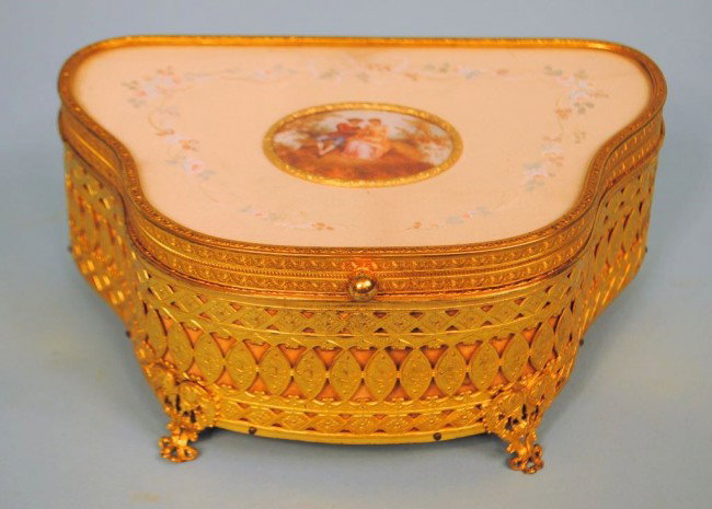 Gilt Ormolu Jewelry Box with Inset Limoges Plaque: A reticulated gilt ormolu jewelry box, the lid inset with a handpainted Limoges plaque surrounded by a handpainted silk background, velvet interior. 3 1/2"h x 8"w x 5 1/4"d.