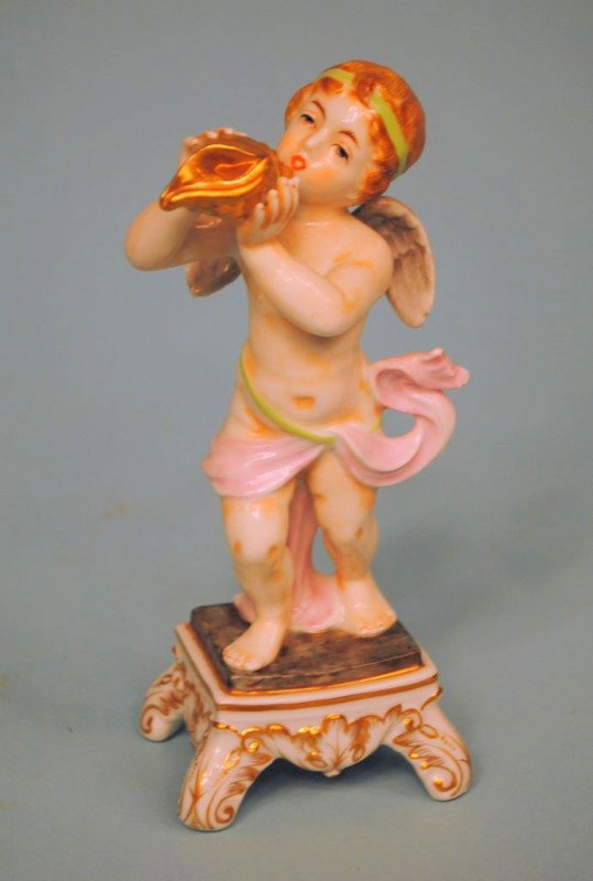 Capo di Monte Cherub with Conch Shell: A finely modeled and handpainted Capo di Monte 6 3/4"h figure of a cherub blowing a gilded conch shell. 40-50 years old.