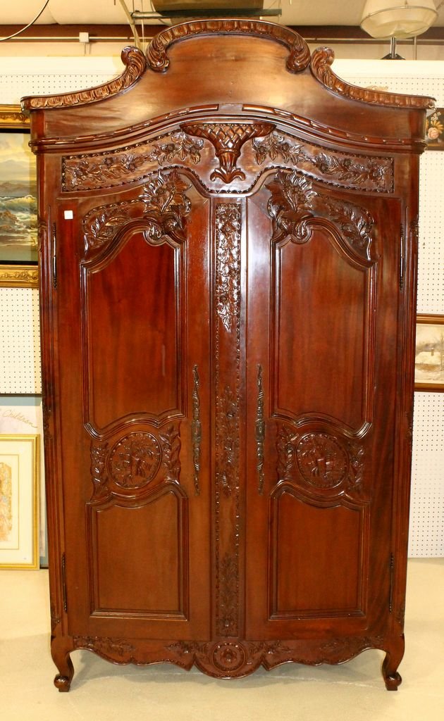 Ornate Mahogany Two Door Armoire: Hand crafted two door mahogany armoire with carved flowers, basket and curved top. Interior has three shelves; 48''w., 22''d., 61''h.
