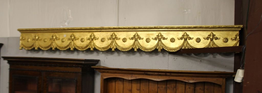 Pair of Gold Leaf Cornices: Pair of gold leaf cornices. Gold leaf cornices with swags and rosettes. 9' 4" w., 8" d., 12" h.