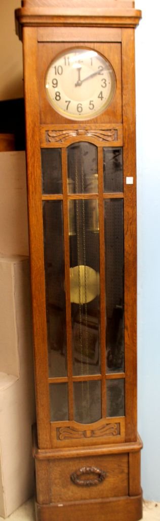 1920's Oak Mission Style Grandfather Clock: Mission style grandfather clock with nine beveled glass panels; 16 1/2" w., 9" d., 83" h.