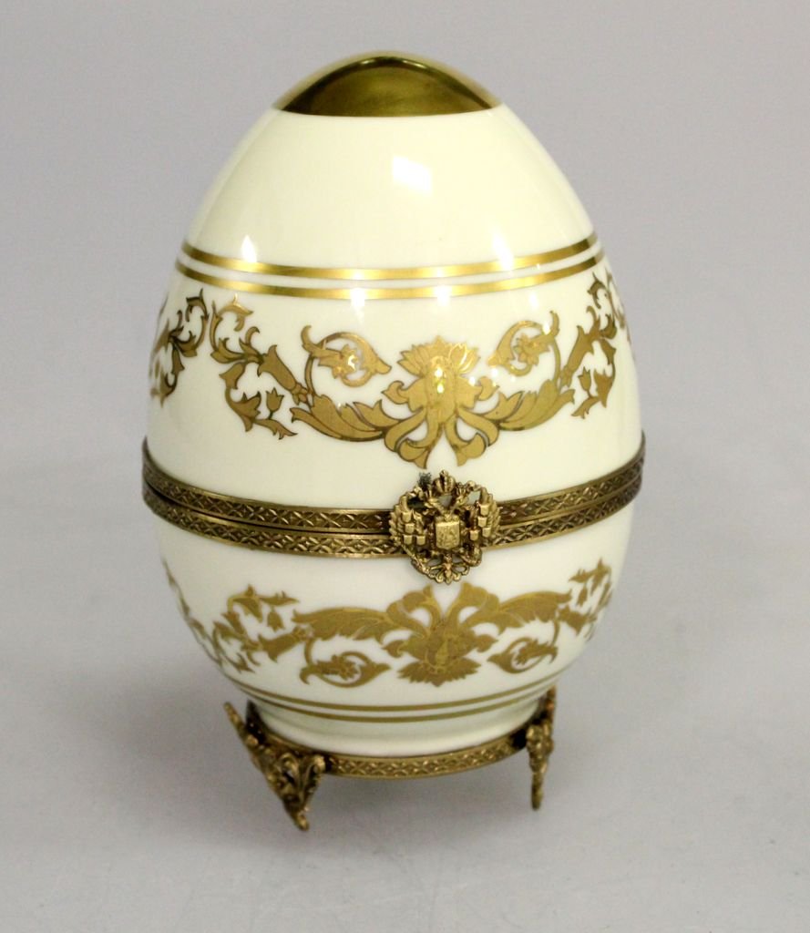 24K Gold Plated Limoge Egg with Couple Inside: From Faberge collection 24k gold plated Limoge egg with couple inside, in original box.; 5 1/2" h.