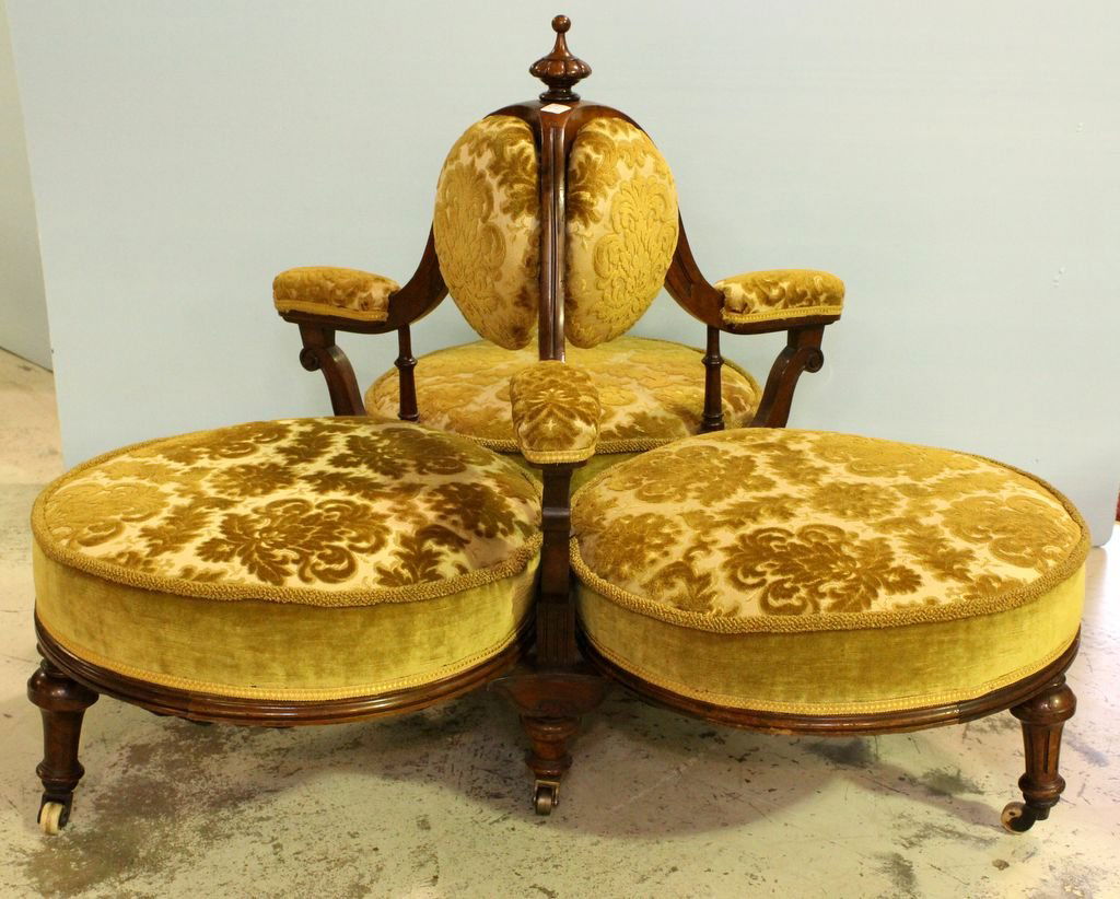 19th Century Walnut Tete a Tete Settee: Rare 19th century walnut Victorian Tete a Tete settee consisting of three sitting areas. Covered in velvet, has original porcelain casters.; 45" dia., 35" h.