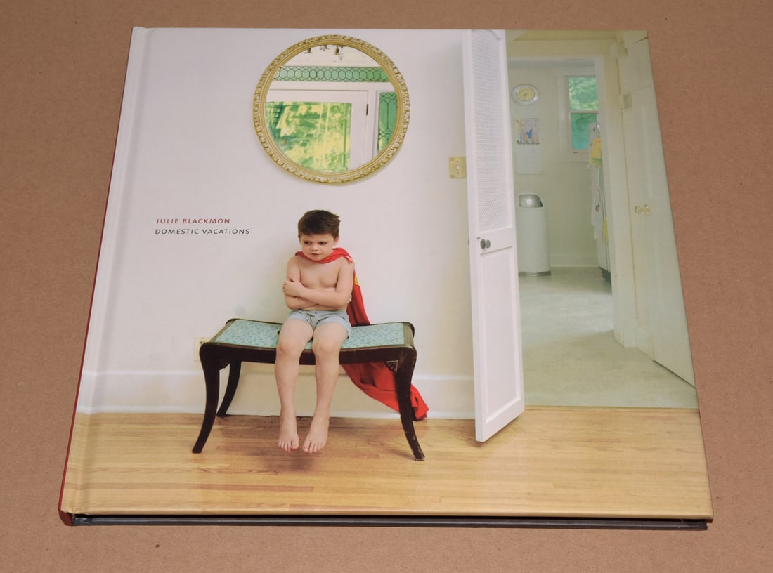 Julie Blackmon (1966 - ) Signed - Domestic Vacations 2008 Hardcover First Edition - Rare: Signed!! You'll most likely see this book (signed) online with asking prices higher than my auction starting price Hardcover 11.25 x 11.25 inches 96 pages - 43 images The Dutch saying “a Jan Steen h