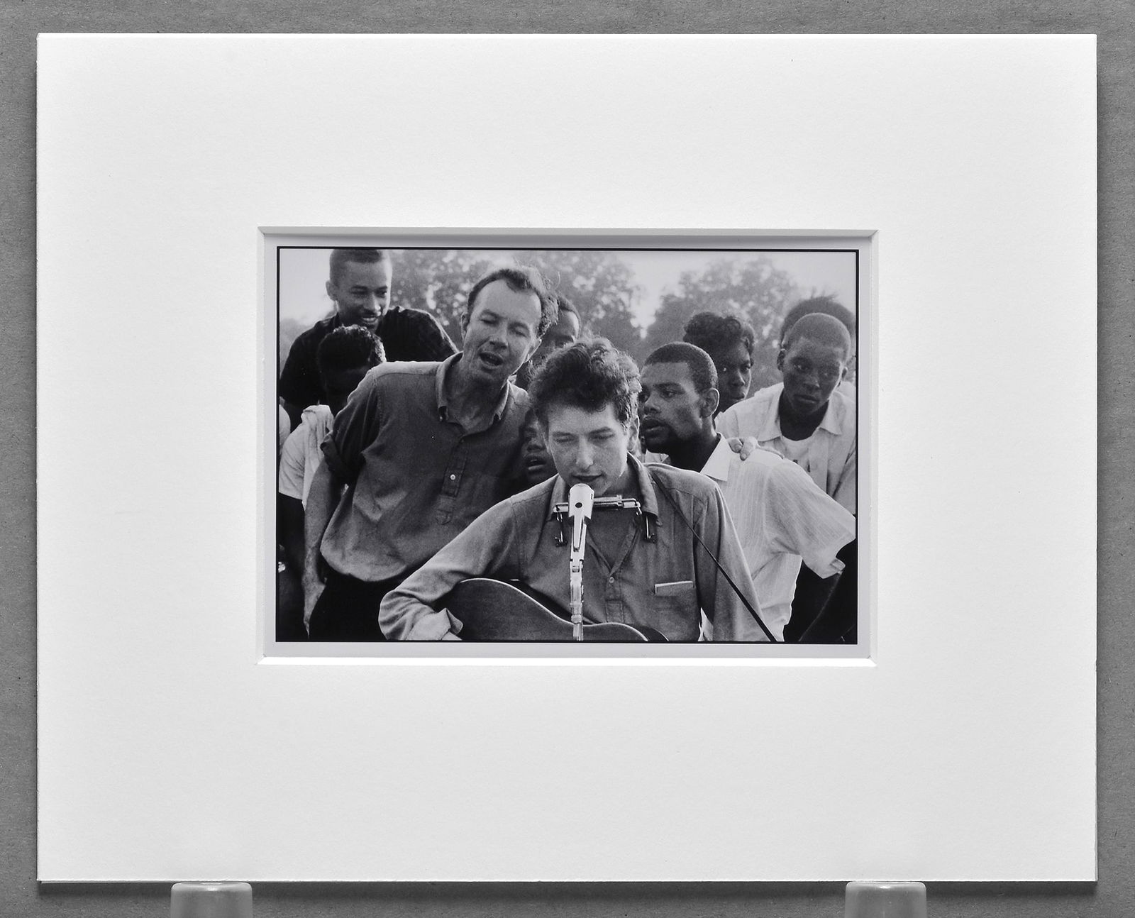 Danny Lyon (1942 - ) Signed 1963 Bob Dylan - Freedom Concert - Greenwood Ms. 4"x5.5" Photograph: Digital C-print photograph printed on 6"x6" paper Signed on the back, corner mounted and matted with 8"x10" museum board. “On July 6, 1963, SNCC held a concert on Silas Magee’s farm in Greenwood,