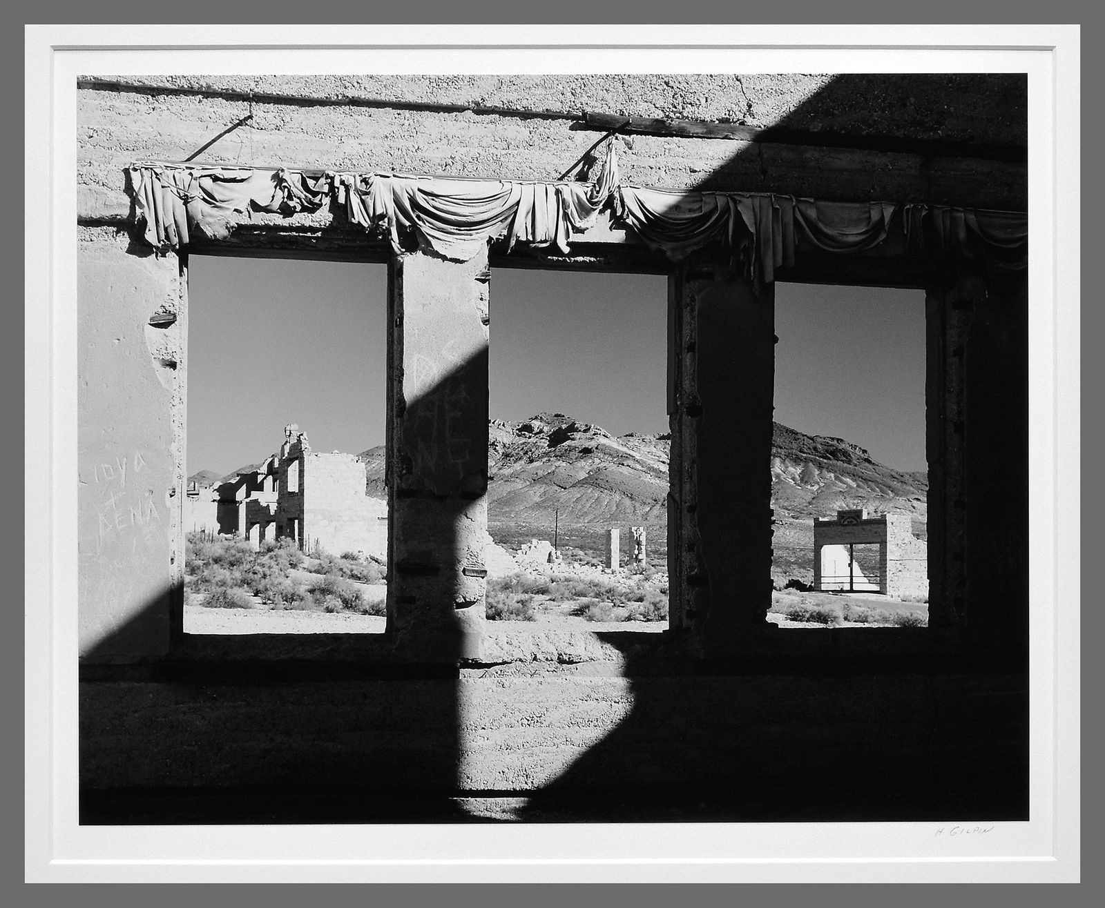 Henry Gilpin (1922-2011) Signed 1988 Rhyolite - Nevada 13.5"x10.5" Photograph - Vintage - Rare: Echoing the iconic 1938 Rhyolite studies by Edward Weston, this rare vintage print by Henry Gilpin delivers the same modernist power—without the $8,000+ price tag. A rare and compelling vintage phot
