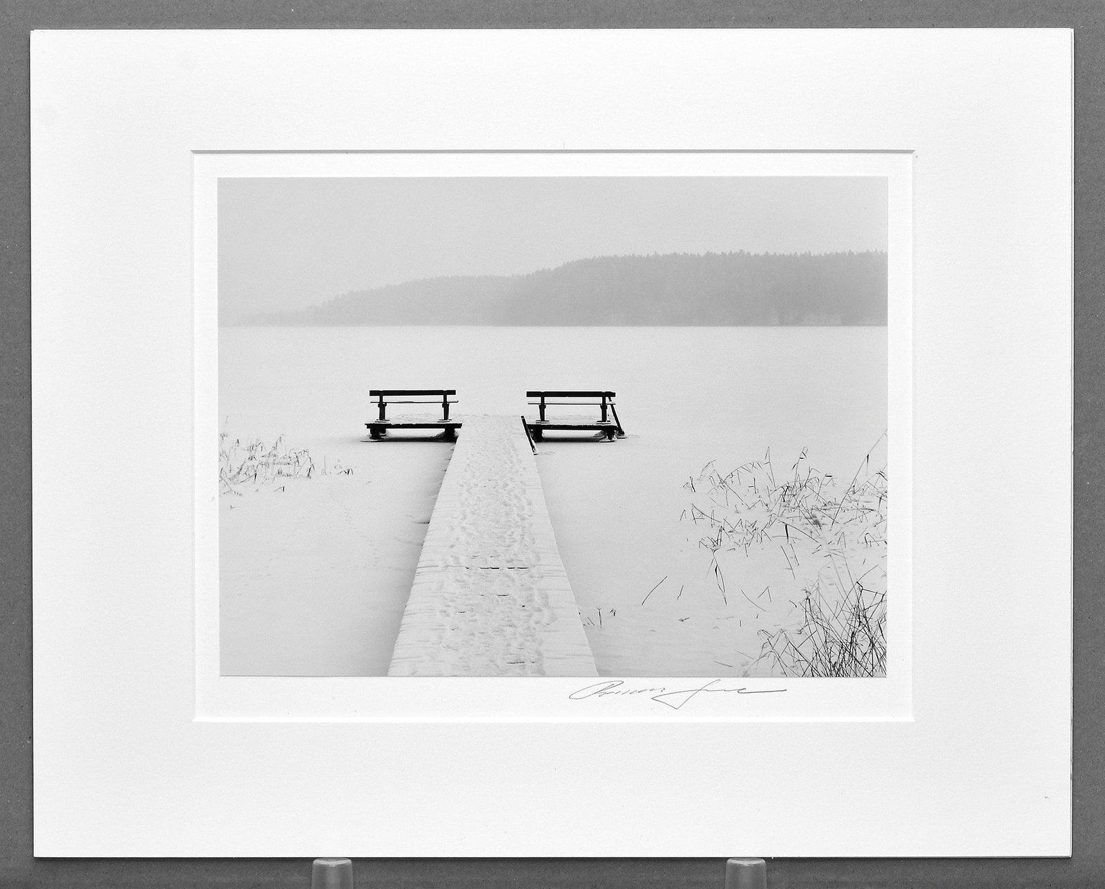 Roman Loranc (1956-) Quietude, 2010 Photograph 9.5"x12.5" Level 2 Tier Price! $2000.: A serene and atmospheric winter landscape by Roman Loranc, capturing a moment of stillness and quiet beauty. Quietude (2010) presents a solitary walkway extending across a frozen, snow-covered lake—