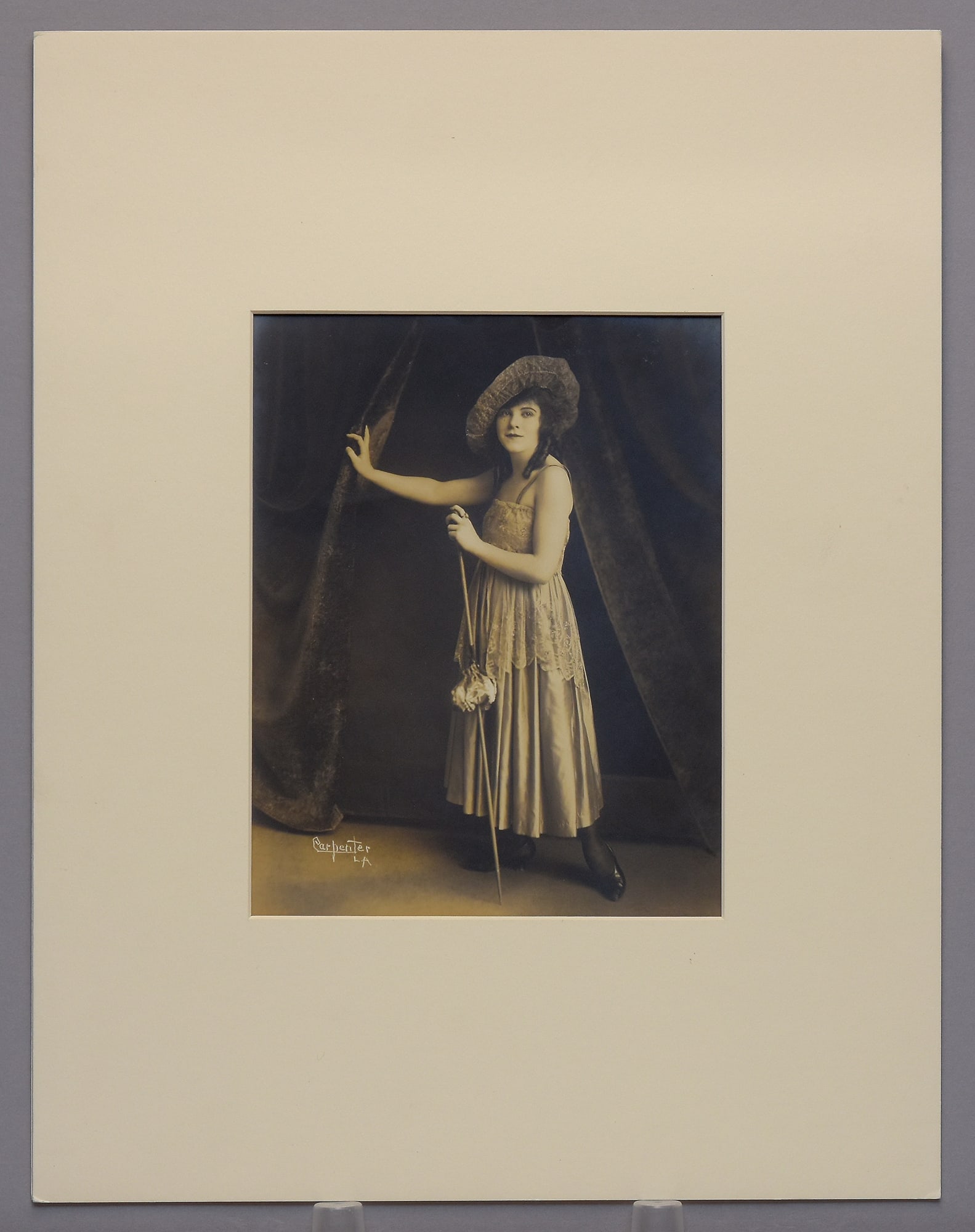 Carpenter Studio L.A. - Portrait of Young Actress, c1915 Photograph 9.5"x7.5" Toned: A visually compelling vintage photograph, offered here at an exceptionally low opening bid. This photograph reflects the classic qualities of its period, with strong composition and tonal character th