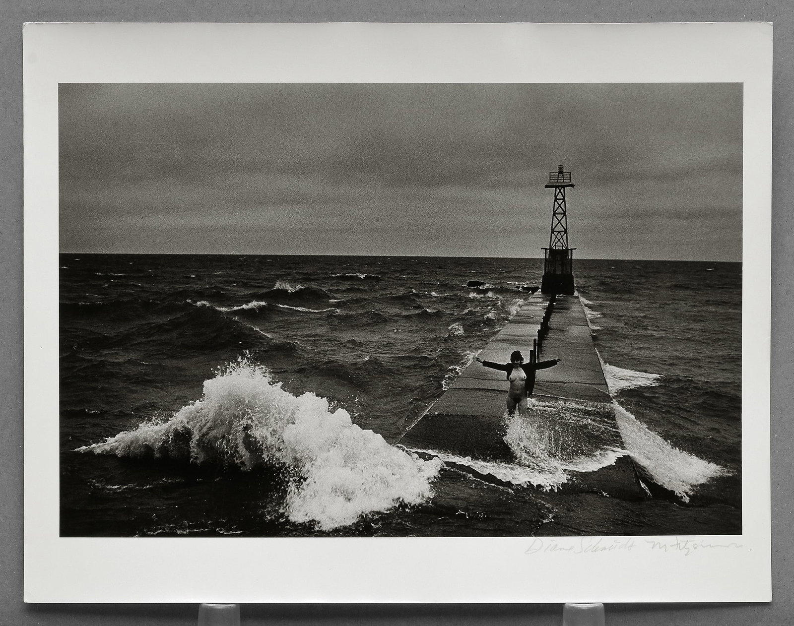 Diane Schmidt - Montrose Harbor 8.5"x12.5" Photograph - Signed by both Schmidt & Fitzsimmons (Model: Rare vintage gelatin silver photograph from Diane Schmidt’s celebrated The Chicago Exhibition series (1979–1984), exploring the relationship between the human form and the urban landscape through 