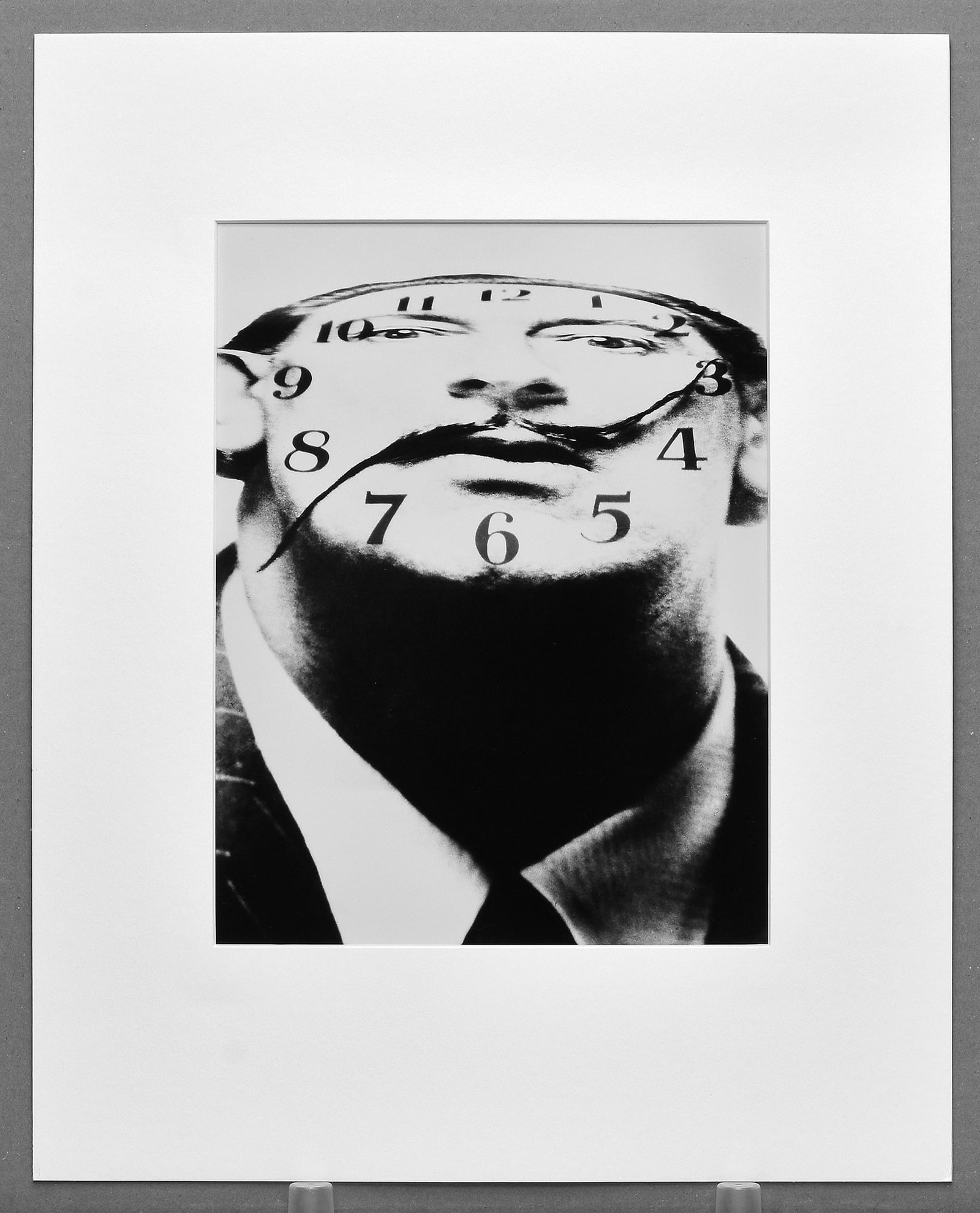 Philippe Halsman (1906-1979) Salvador Dalí, Clockface, 1953 Photograph 12.5"x9.5" Edition #84/250: An iconic collaboration between Philippe Halsman and Salvador Dalí, this striking image transforms the artist’s face into a surreal clock — one of the most recognizable and inventive portraits fr