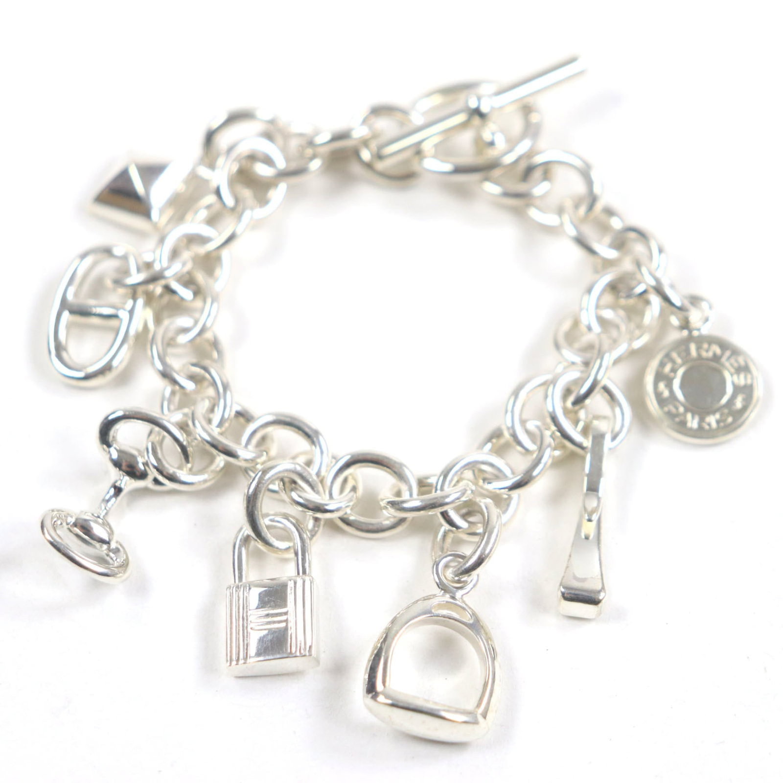 Hermes Amulet 7 925 Silver Serie Cadena Medor Chaine D'Ancre Horsebit Etrier Bracelet: Brand: Hermes Type: Charm Bracelet Gender: Women Metal: Silver Metal Purity: Silver925 Length: 16cm / 6.29'' Weight: 62.46g / 2.2oz. Condition: Used (very good), A few traces of usage, some scratches
