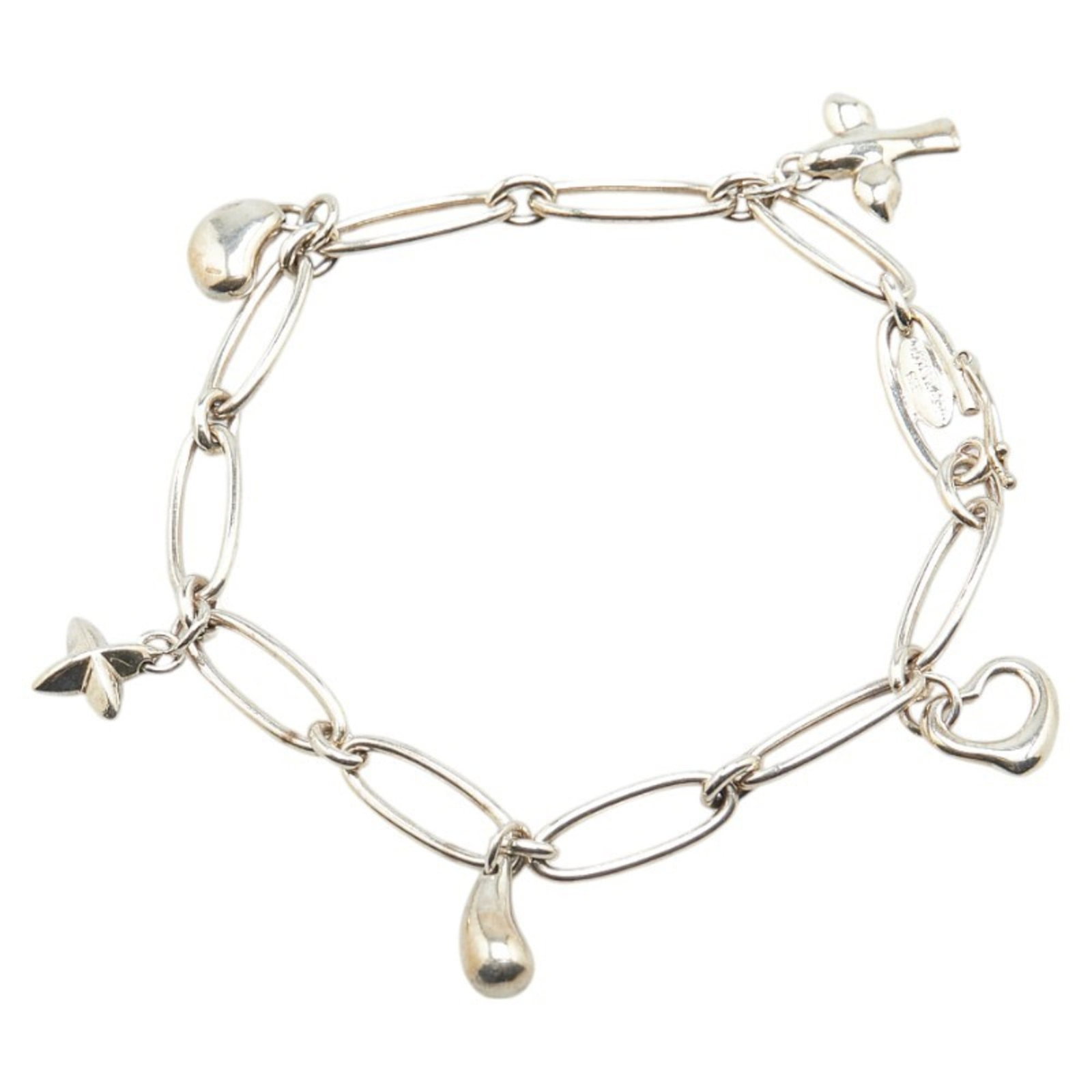 Tiffany & Co. 5-Charm Bracelet In 925 Sterling Silver: Brand: Tiffany Type: Charm Bracelet Gender: Women Material: Silver 925 Length: 17cm / 6.69'' Width: 5mm / 0.19'' Weight: 11.9g / 0.41oz. Condition: Used (good), Traces of usage, scratches / dirt can b
