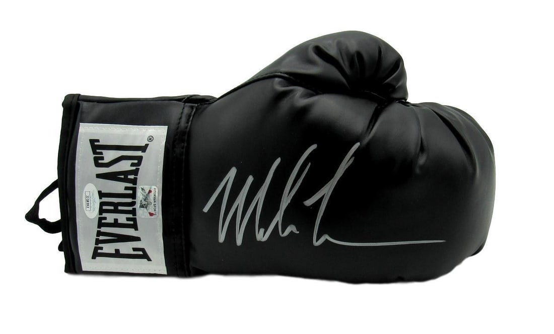 Mike Tyson Boxing Champ Signed/Auto Black Everlast Boxing Glove Right JSA 149809: Mike Tyson Boxing Champ Signed/Auto Black Everlast Boxing Glove Right JSA 149809 An original black Everlast boxing glove signed by boxing champion Mike Tyson, authenticated by JSA, suitable for collec
