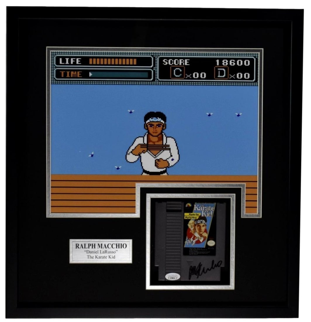 Ralph Macchio Karate Kid 11x14 Photo with Autographed Nintendo Game Framed 98331: Ralph Macchio Karate Kid 11x14 Photo with Autographed Nintendo Game Framed 98331 This item features an 11x14 photo of Ralph Macchio from the Karate Kid, signed and accompanied by an autographed Ninten