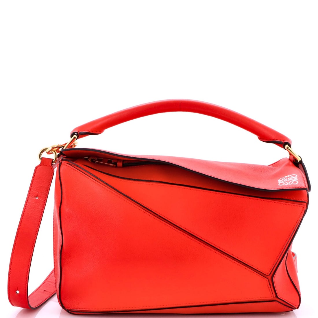 Medium Loewe Puzzle Bag Leather: Medium Loewe Puzzle Bag Leather Medium Loewe Puzzle Bag in red leather, includes a strap and measures 7"H x 11"W x 5.5"D; condition is very good with minor wear and is accompanied by gold hardware. It