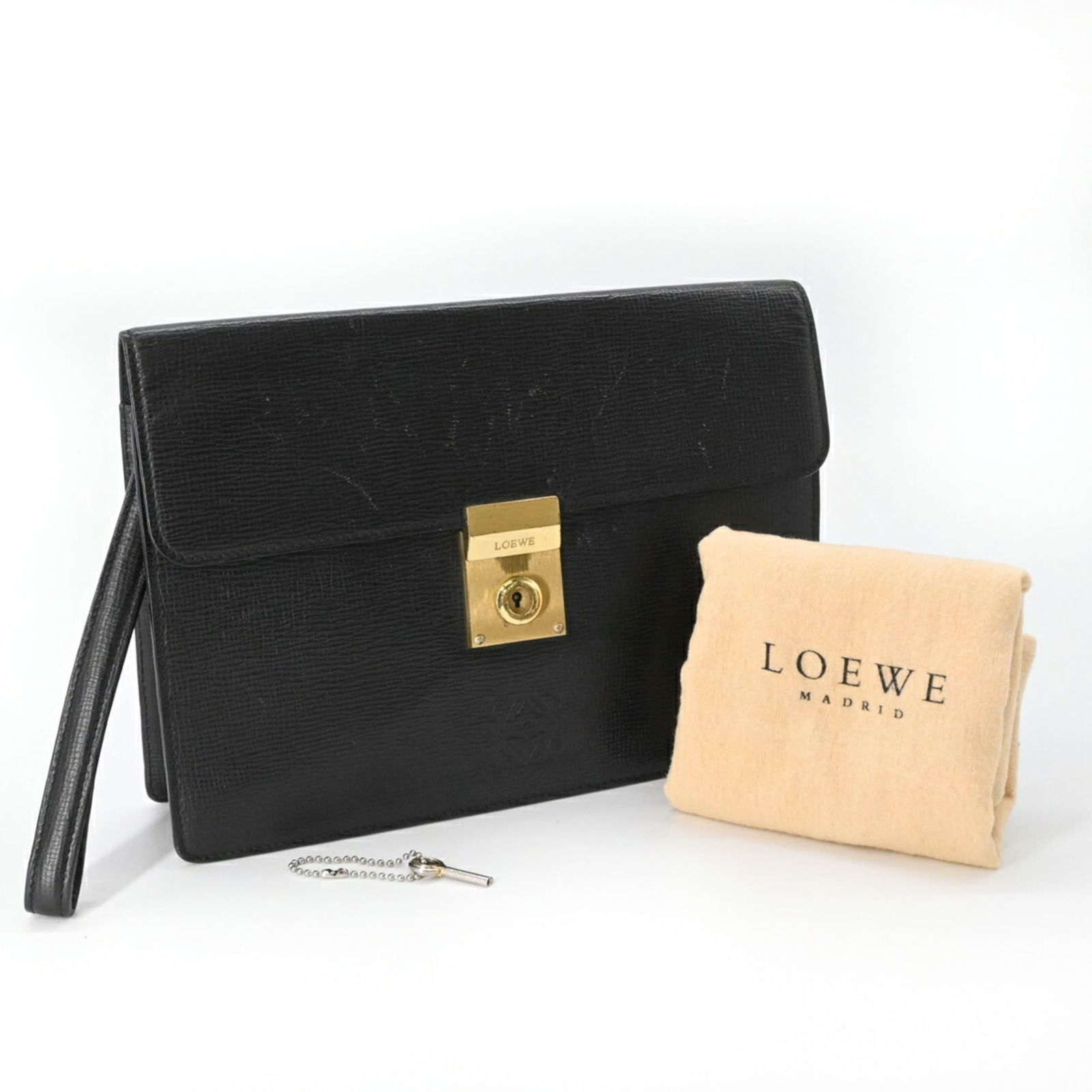 Loewe Leather Clutch Bag: Loewe Leather Clutch Bag Loewe leather clutch bag in black for men, measuring 19cm x 26cm x 4.5cm, showing good condition with some wear and scratches. Item Specifics: Brand: Loewe Type: Clutch Bag Ma