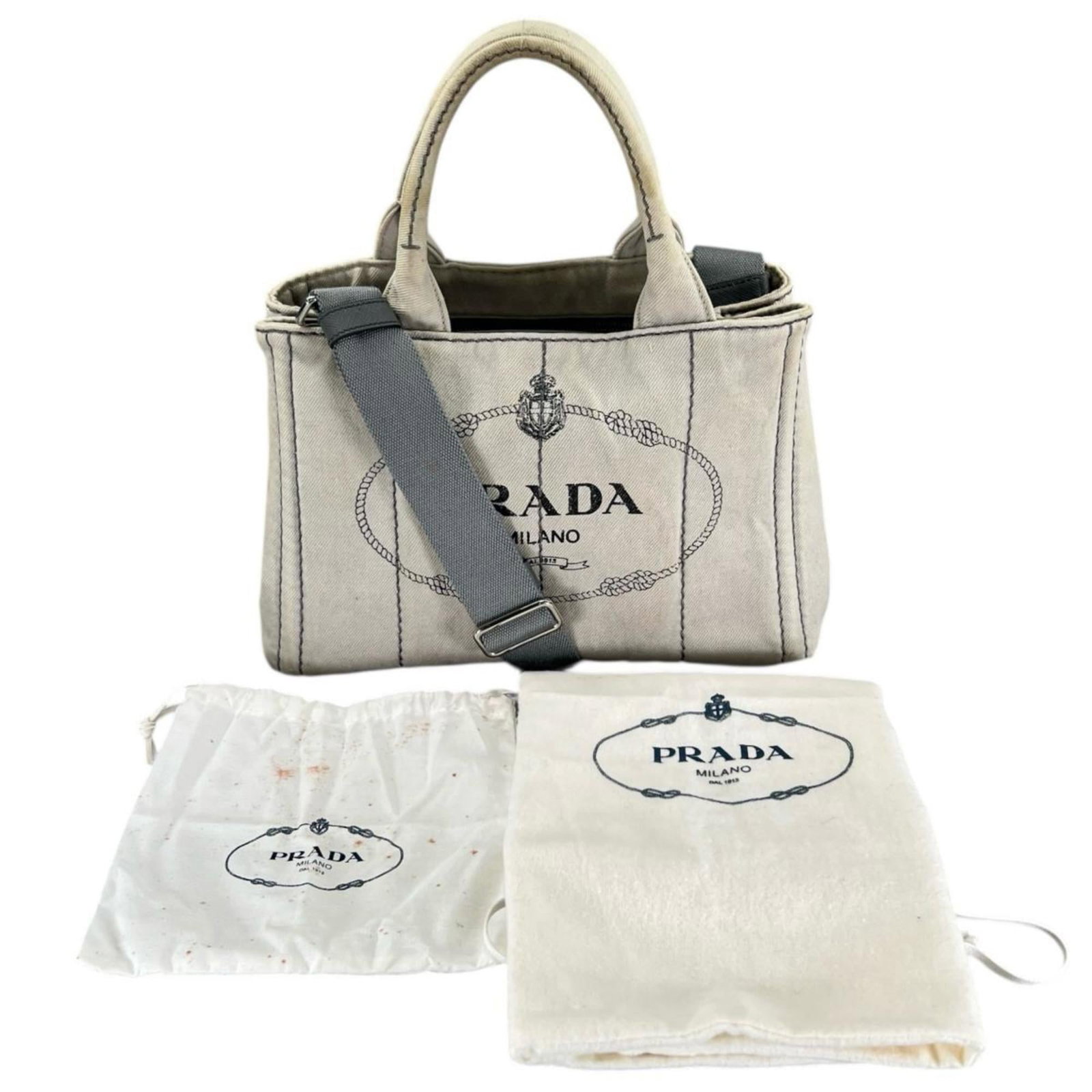 Prada Denim Tote Bag: Prada Denim Tote Bag Prada's denim tote bag for women measures 19cm x 28cm x 14cm, is white in color, and is used with visible wear but remains in acceptable condition for continued usage. Item Specif