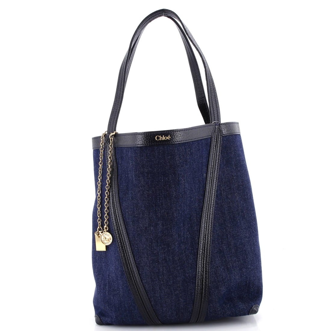 Chloe Medium Spin Tote in Denim: Chloe Medium Spin Tote in Denim The Chloe Medium Spin Tote is a denim bag in blue and black, measuring 12" in height, 10" in width, and 5.5" in depth, with minor signs of wear and gold hardware. 