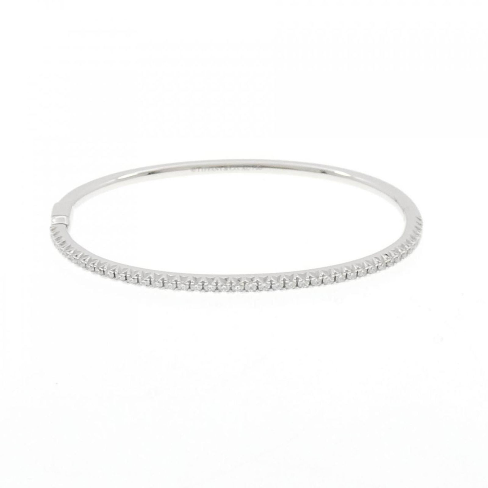 Tiffany 18K White Gold Bangle: Tiffany 18K White Gold Bangle Tiffany 18K White Gold Bangle for women, measures 15.5cm (6.1 inches) in length, features a diamond, and is in like-new condition. Item Specifics: Brand: Tiffany Type: Ba