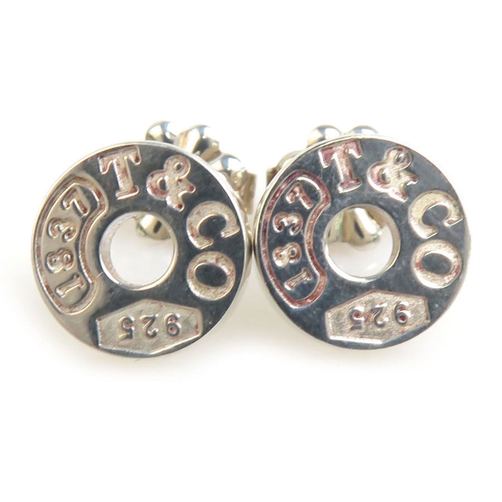 Tiffany Silver 925 Stud Earrings: Tiffany Silver 925 Stud Earrings These used Tiffany stud earrings are made of Silver 925, designed for women, and show traces of usage with some scratches but are generally in good condition. Item