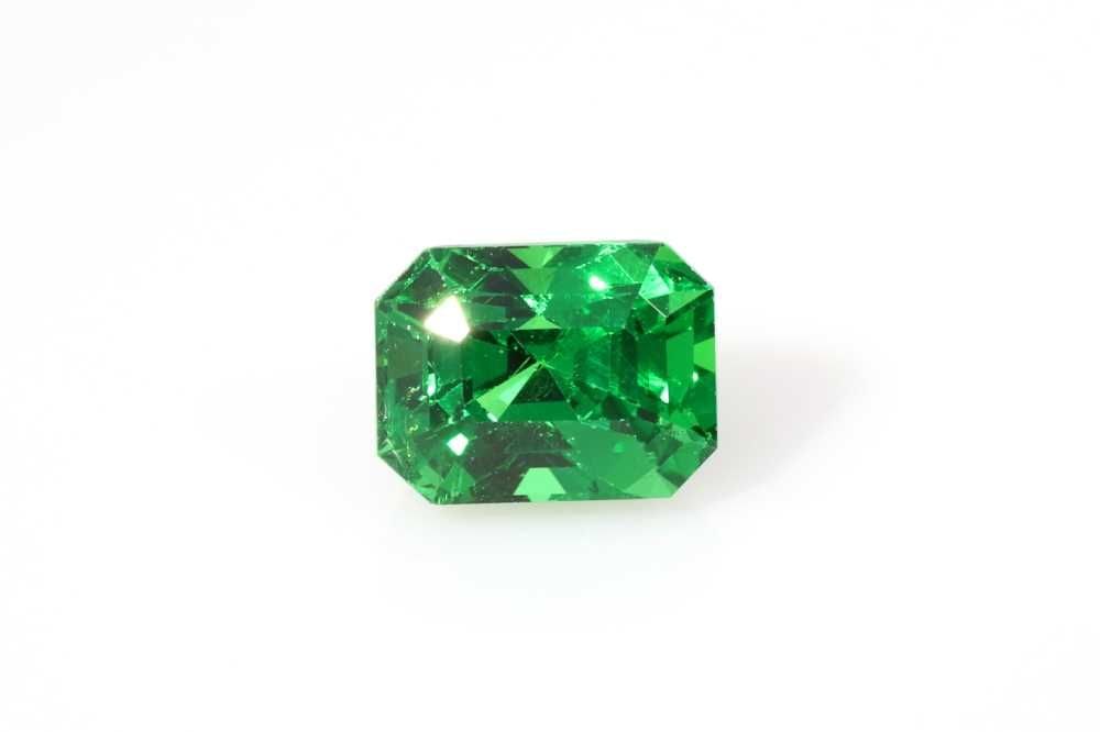 Loose Emerald Garnet Gemstone 1.53ct Green EC: Loose Emerald Garnet Gemstone 1.53ct Green EC This loose emerald garnet gemstone weighs 1.53ct and features a vivid green color with a faceted cut. It measures 6.9mm in length and 5.3mm in width, and