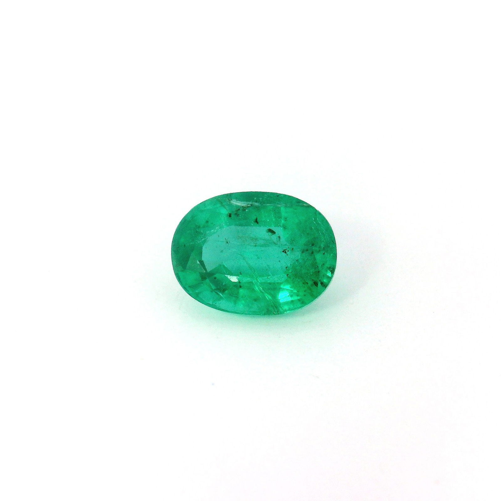 Loose Green SI Oval 1.57ct Emerald Gemstone - GSI: Loose Green SI Oval 1.57ct Emerald Gemstone - GSI Loose 1.57ct green emerald gemstone with a faceted cut, medium intense color shade, and SI clarity, certified by GSI, measuring 8.23L x 6.21W. Item