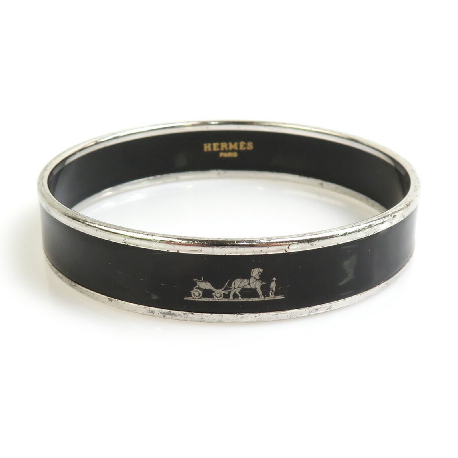 Enamel Metal Bangle by Hermes: Enamel Metal Bangle by Hermes Hermes enamel metal bangle for women, featuring black and silver colors, measuring 19.3cm, in good used condition with traces of usage. Item Specifics: Brand: Hermes Type