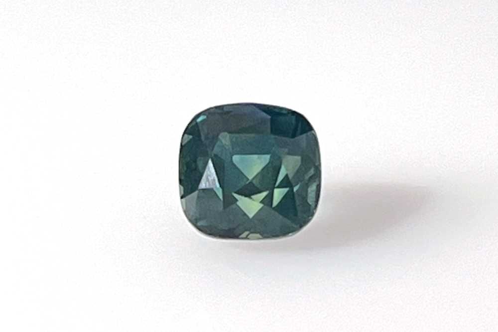 Loose Sapphire Gemstone 2.6ct Cushion Teal EC GIA: Loose Sapphire Gemstone 2.6ct Cushion Teal EC GIA This 2.6ct cushion cut teal sapphire has EC clarity and has been heated, with measurements of 7.0L x 6.95W, and is certified by GIA. Item Specifics: T