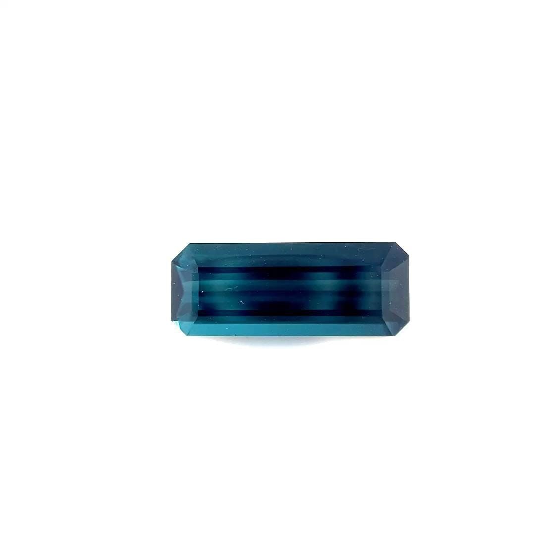 Loose Tourmaline Gemstone Emerald 3.35ct Blue SI: Loose Tourmaline Gemstone Emerald 3.35ct Blue SI Loose tourmaline gemstone in emerald cut, weighing 3.35ct, blue color (indicolite), with clarity SI and no treatment. Measurements: 15.1L x 6.0W. 