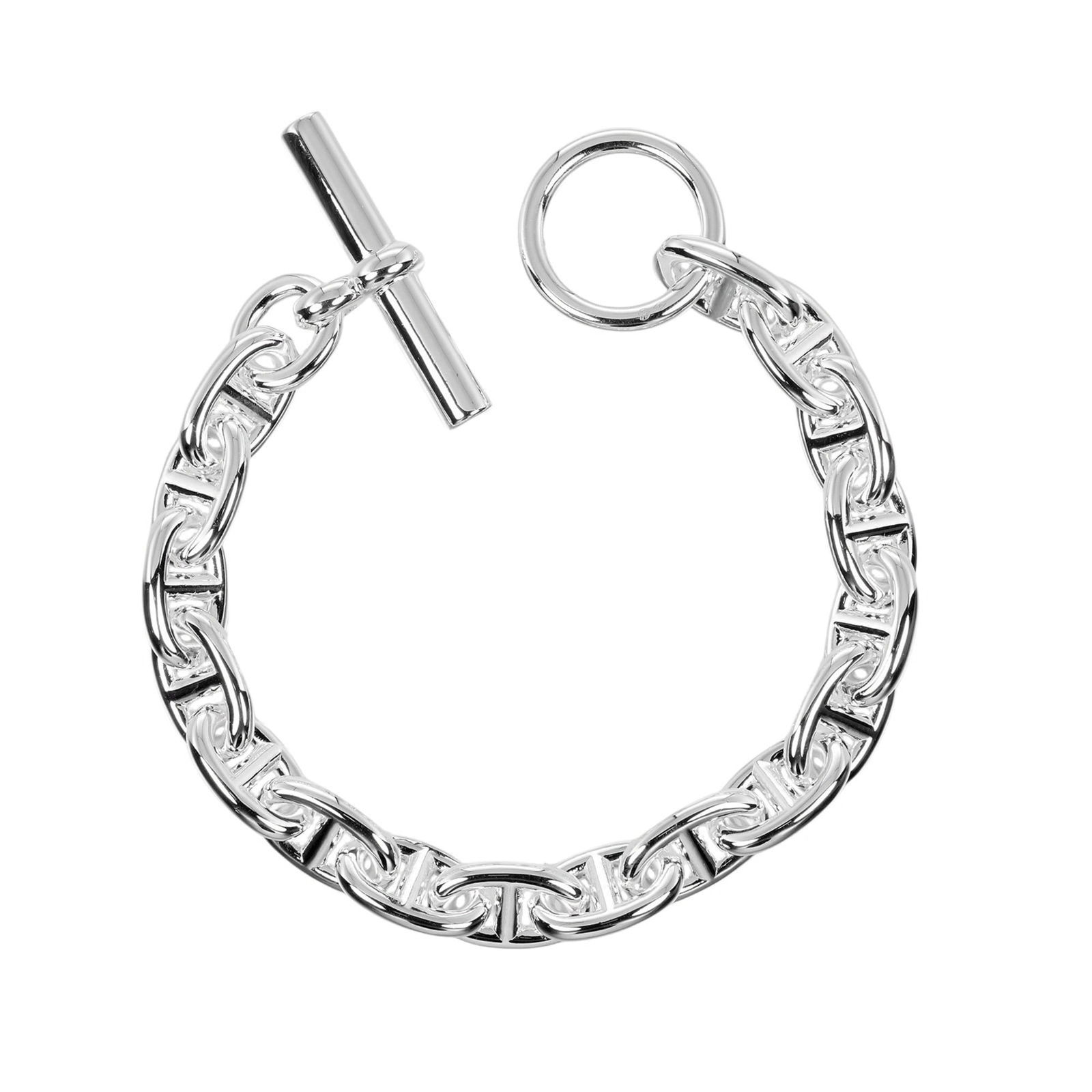 Hermes Silver 925 Charm Bracelet: Hermes Silver 925 Charm Bracelet Hermes Silver 925 Charm Bracelet for women, measuring 15.5cm in length and weighing 38g, is in very good used condition with minor scratches and traces of usage. 