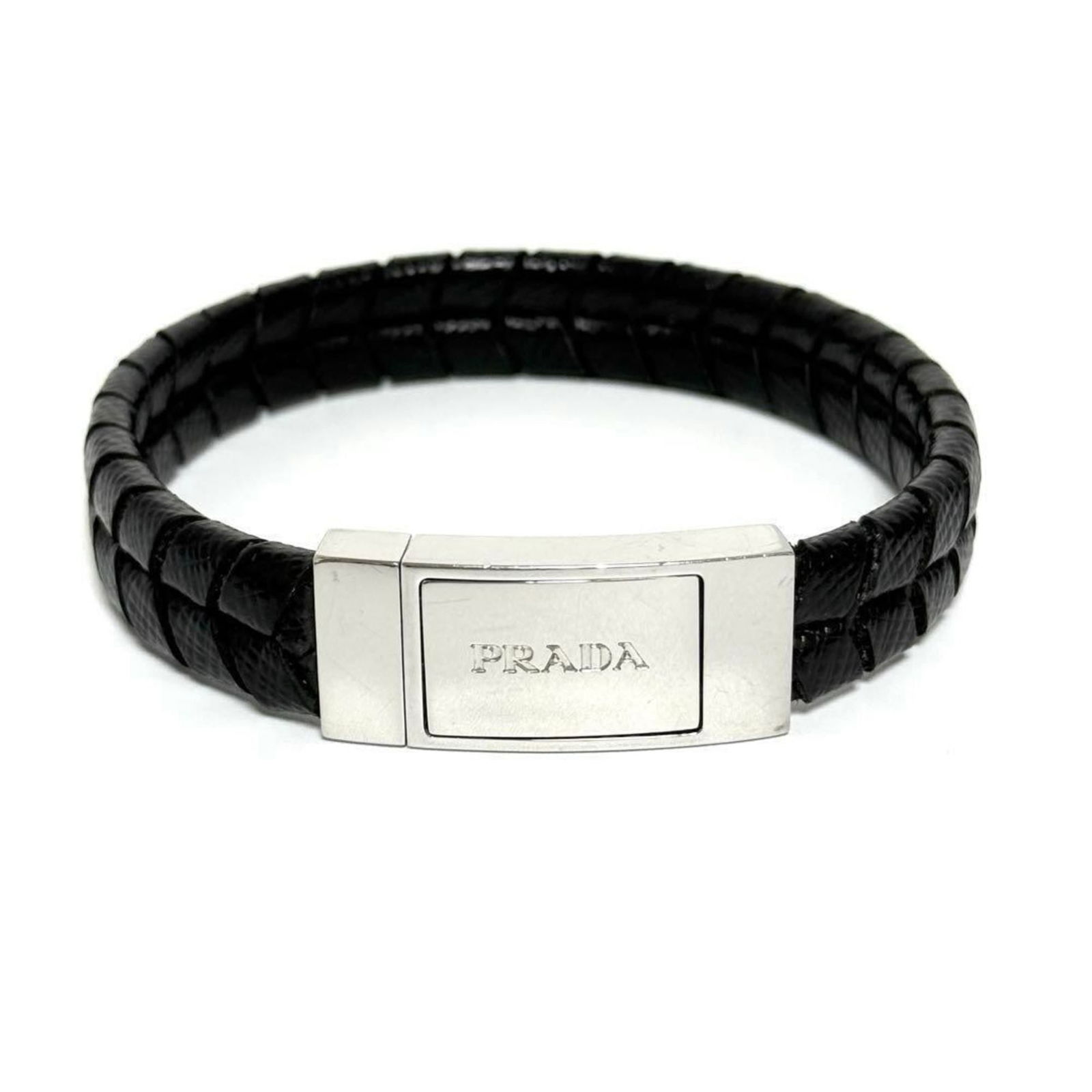 Prada Leather, Metal Bangle: Prada Leather, Metal Bangle Prada's bangle, suitable for both men and women, is made of leather and metal, measuring 19cm in length. It is in very good condition with some signs of usage. Item Specifi