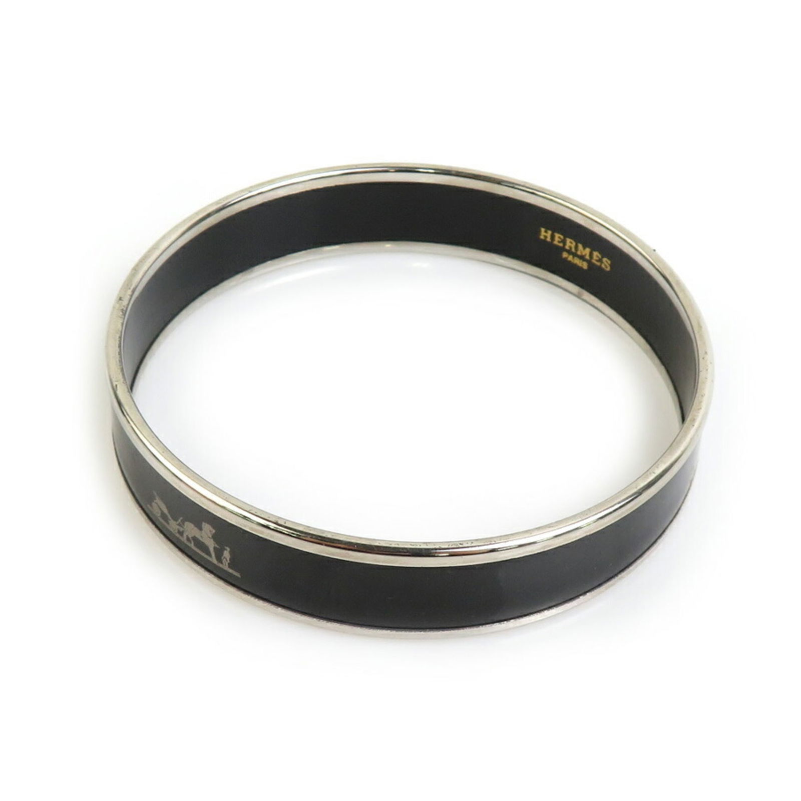Enamel Metal Bangle by Hermes: Enamel Metal Bangle by Hermes Hermes enamel metal bangle for women in black and silver, measuring 19cm in length. It is in good used condition with visible traces of use, including scratches. Item Spe