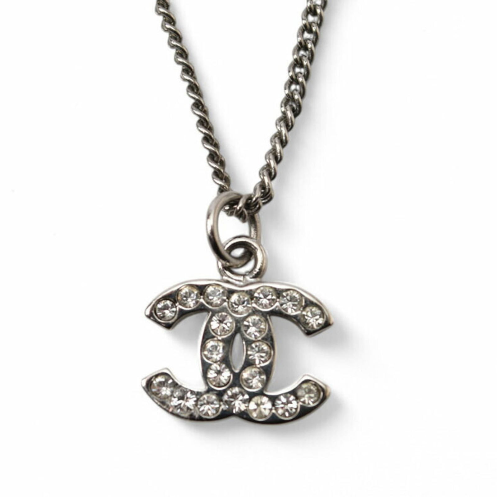 Chanel Rhinestone Metal: Chanel Rhinestone Metal Chanel necklace featuring a metal and rhinestone pendant designed for women, in silver and white, measuring 42 cm in neck circumference. Item Specifics: Brand: Chanel Necklace