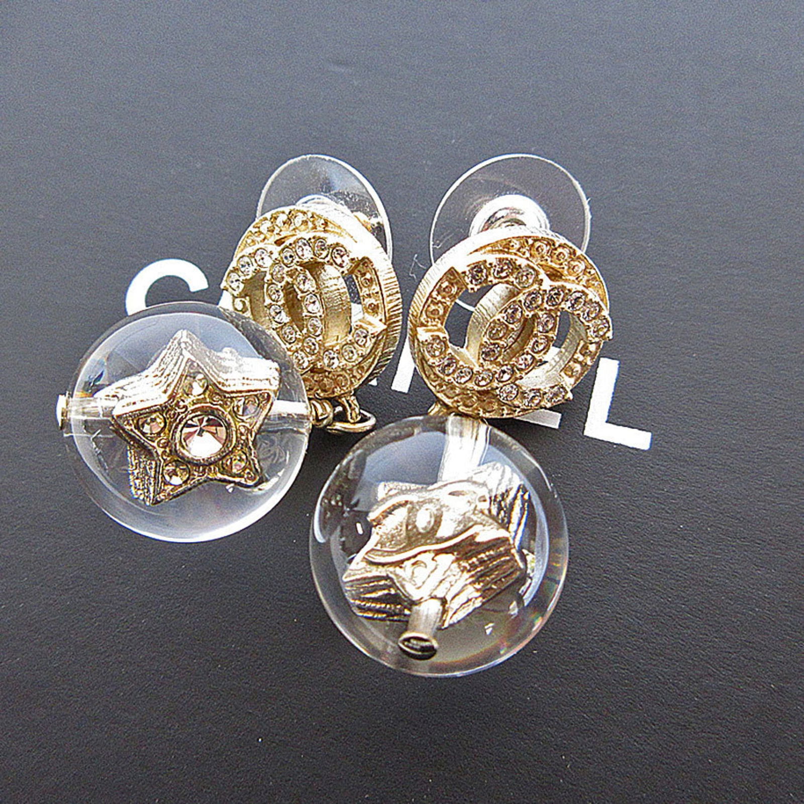 Chanel Metal and Resin Stud Earrings: Chanel Metal and Resin Stud Earrings Chanel Metal and Resin Stud Earrings, suitable for women, in gold and silver color with dimensions of 35.00mm x 15.00mm, showing very good used condition. Item