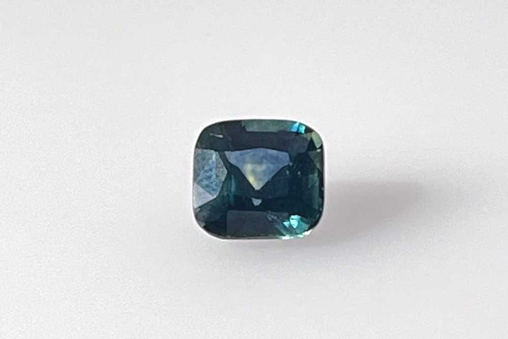 Loose Sapphire Gemstone GIA Cushion 1.44ct Teal EC: Loose Sapphire Gemstone GIA Cushion 1.44ct Teal EC Loose sapphire gemstone weighing 1.44ct, cushion cut with teal color and EC clarity, heated treatment, certified by GIA with dimensions 6.21L x
