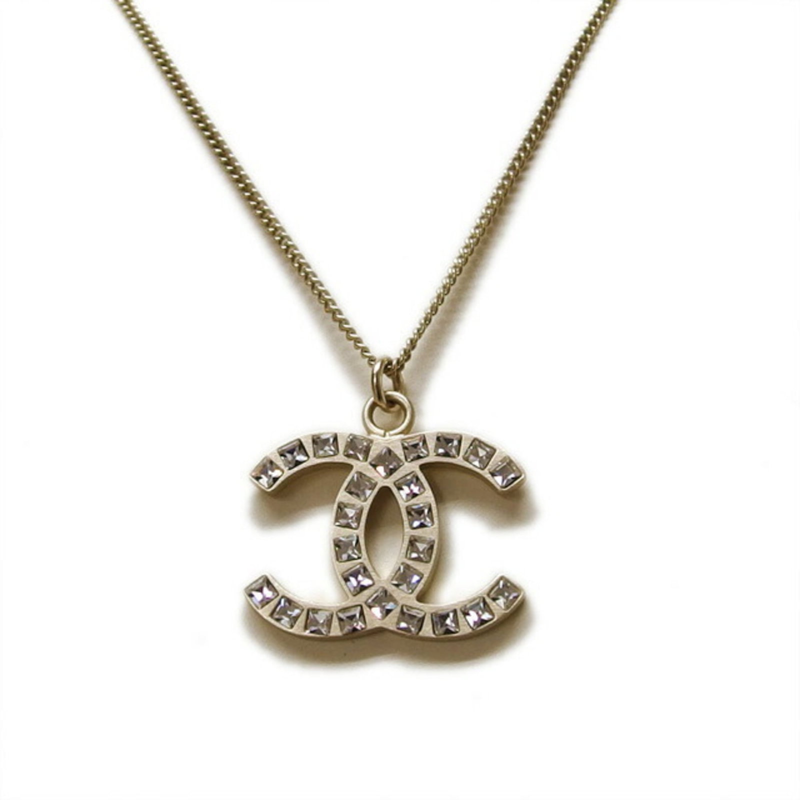 Chanel Rhinestone Necklace Coco Mark B12A: Chanel Rhinestone Necklace Coco Mark B12A Chanel Rhinestone Necklace featuring a champagne gold metal design with a pendant size of 18mm x 24mm and a neck circumference of 42 cm. Condition is very goo