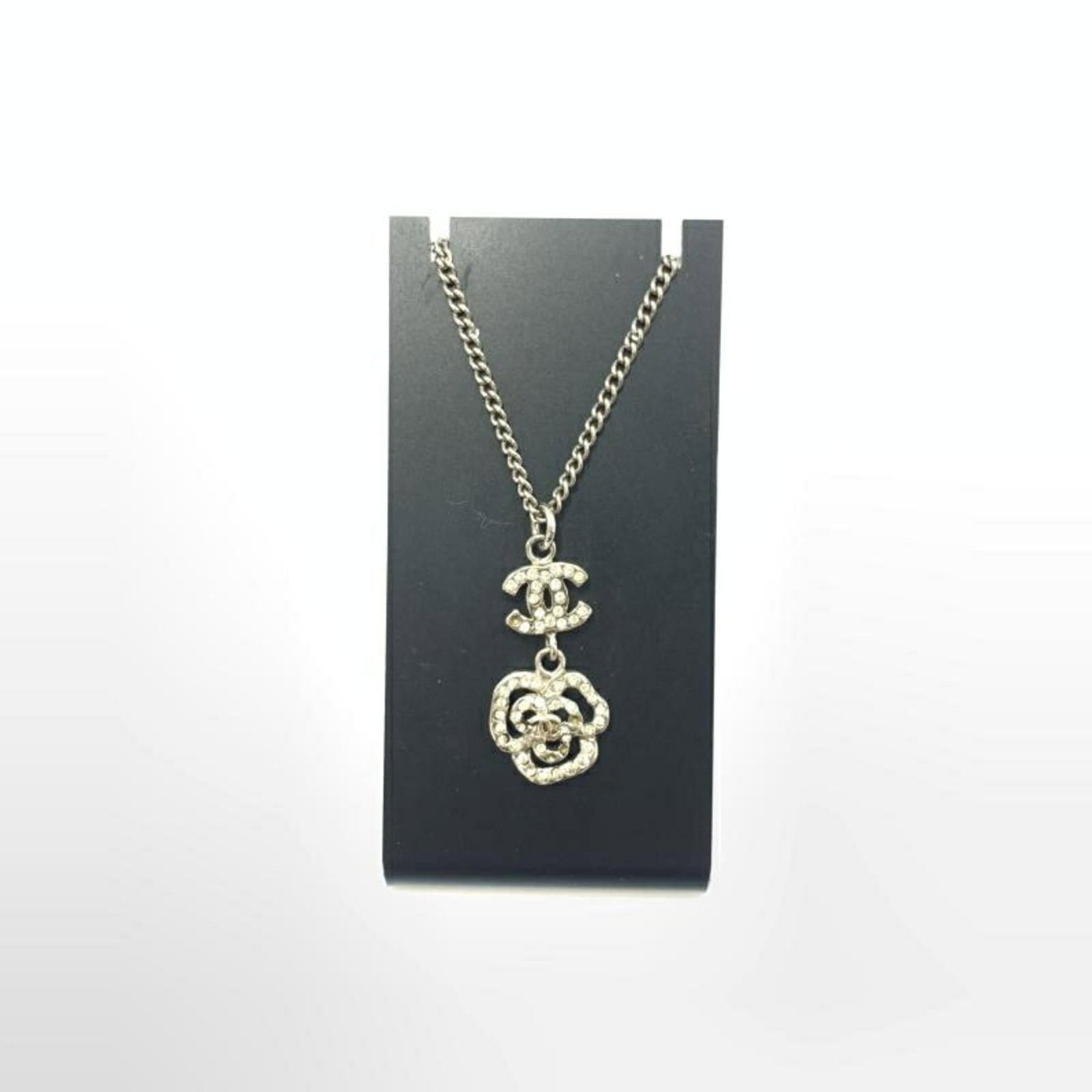 CHANEL Rhinestone Necklace Camellia Coco Mark: CHANEL Rhinestone Necklace Camellia Coco Mark Chanel girls' necklace featuring a Camellia Coco Mark pendant that measures 20mm x 15mm, with a neck circumference of 24 cm. Condition is used
