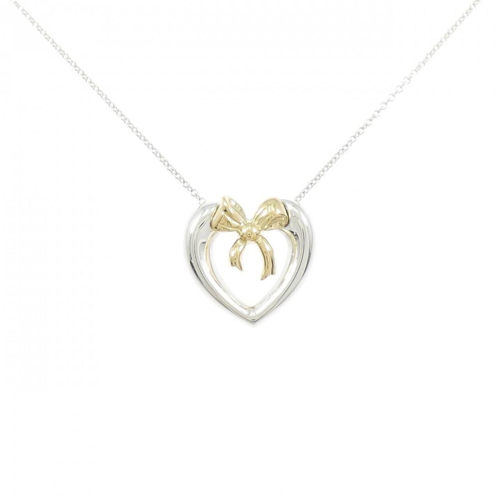 Tiffany 925 750YG Heart x Ribbon Necklace: Tiffany 925 750YG Heart x Ribbon Necklace Tiffany 925 and 750YG heart x ribbon pendant necklace for women, crafted from silver 925 and 18K yellow gold, in used (like new) condition, with a neck