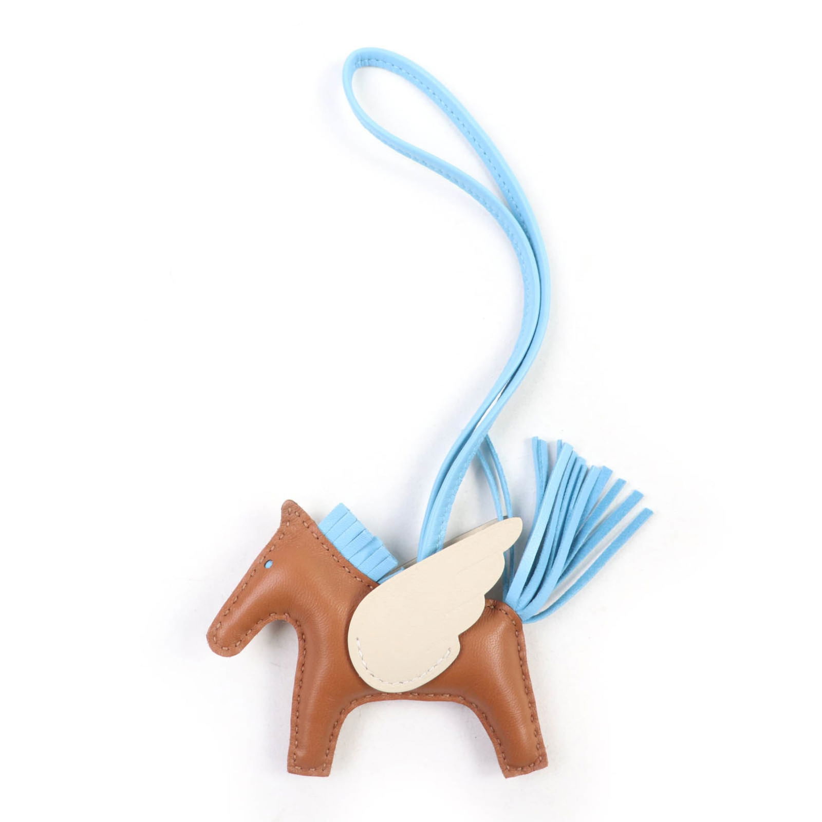 Milo Agneau Handbag Charm by Hermes: Milo Agneau Handbag Charm by Hermes Hermes handbag charm made of Agneau Milo material in Celeste, Cream, and Gold colors, measuring 75mm x 125mm, in like new condition. Item Specifics: Brand: Hermes