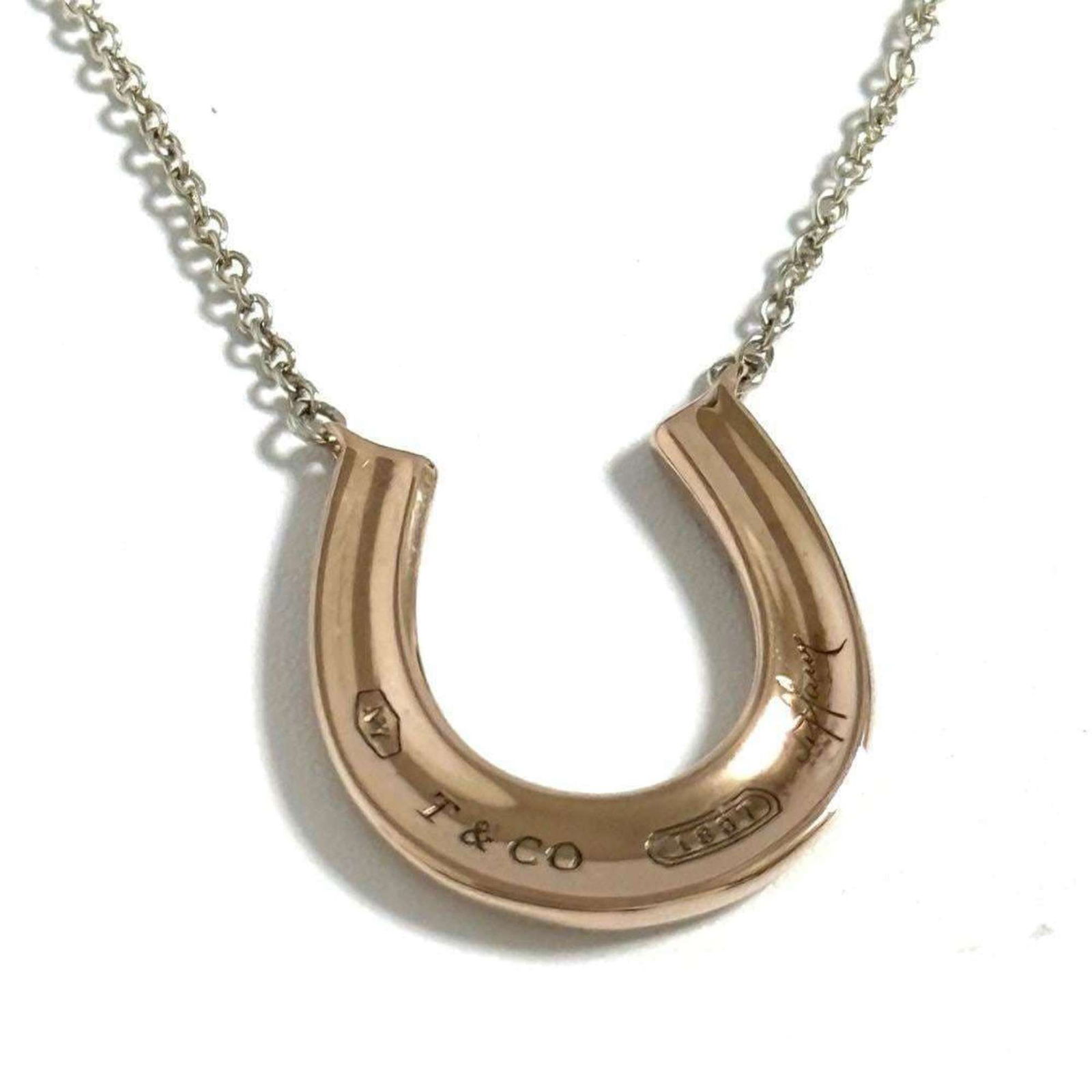 Metal Tiffany Horseshoe Pendant Necklace in Rubedo: Metal Tiffany Horseshoe Pendant Necklace in Rubedo This listing features Metal Tiffany Horseshoe Pendant Necklace in Rubedo. Item specifics are provided below. Item Specifics: Brand: Tiffany Necklace