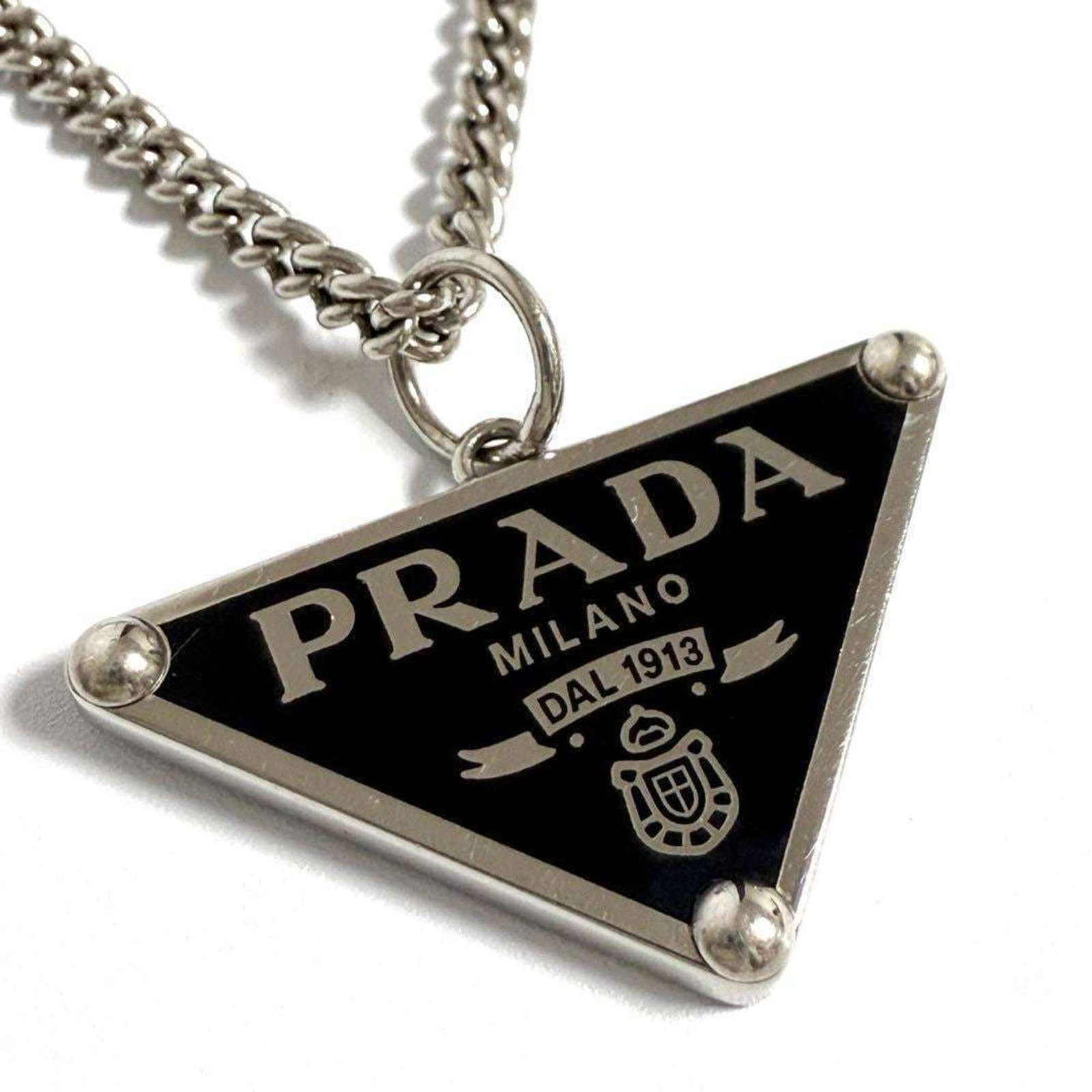 Silver Prada Men's/ Women's Symbol Necklace Pendant in: Silver Prada Men's/ Women's Symbol Necklace Pendant in This listing features Silver Prada Men's/ Women's Symbol Necklace Pendant in. Item specifics are provided below. Item Specifics: Brand: Prada Nec