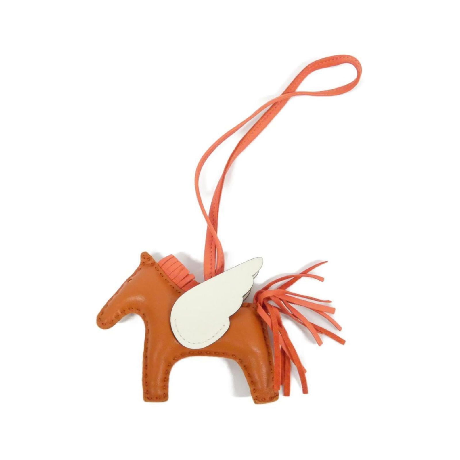 Milo Agneau Handbag Charm by Hermes: Milo Agneau Handbag Charm by Hermes The Milo Agneau Handbag Charm by Hermes is a used accessory in very good condition, made from Agneau Milo leather in orange and white, measuring 70mm x 85mm with a