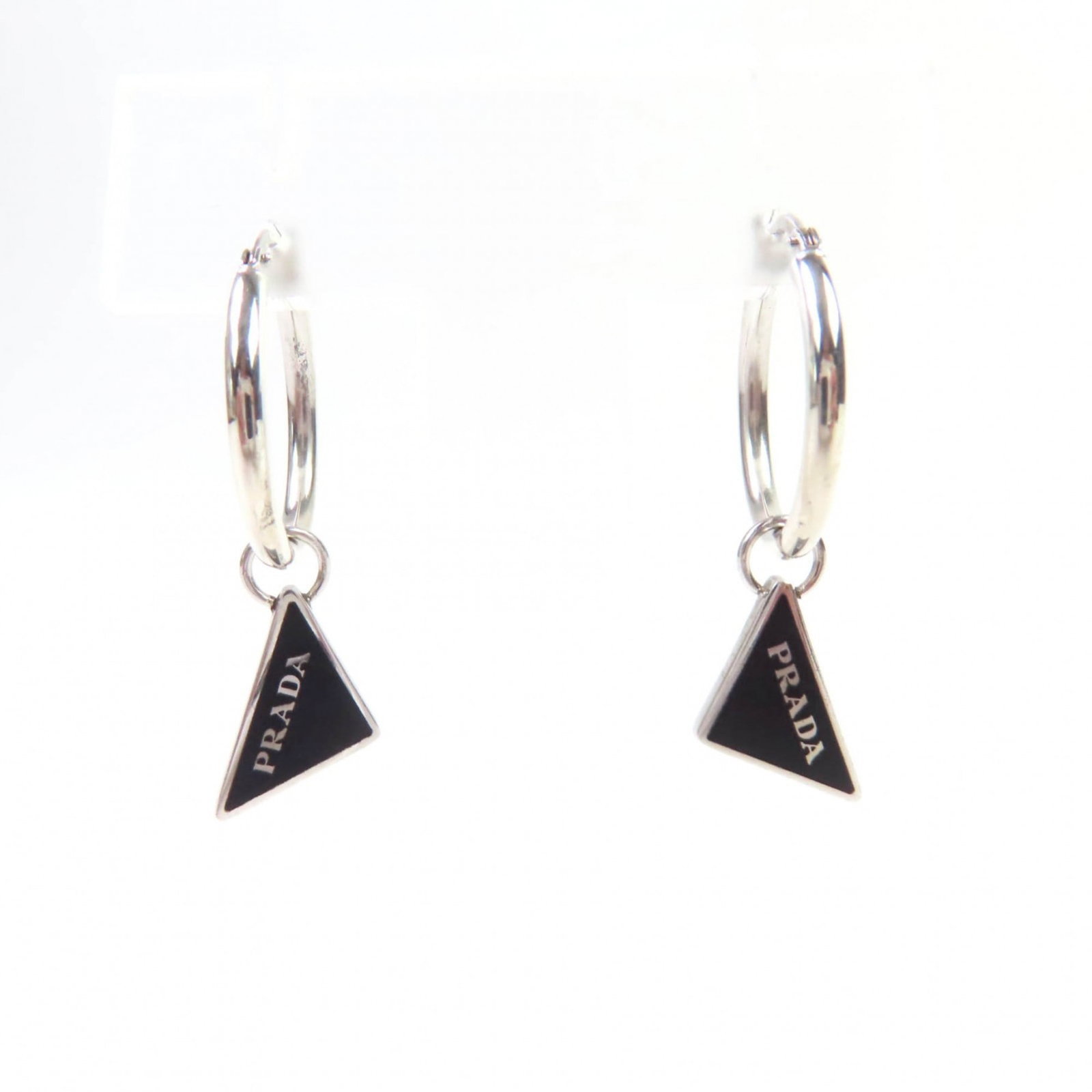 Prada Silver 925 Stud Earrings: Prada Silver 925 Stud Earrings Prada women's stud earrings made of Silver 925, measuring 15.00mm x 8.00mm in black and silver color, in used (very good) condition with minor traces of usage. Item